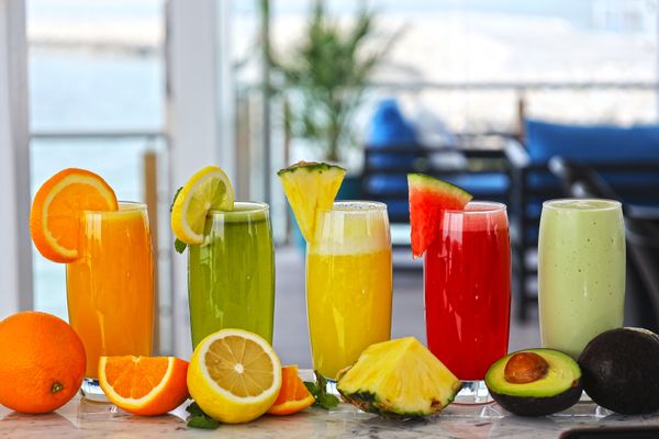 Fresh mixed fruit juices poured at the counter