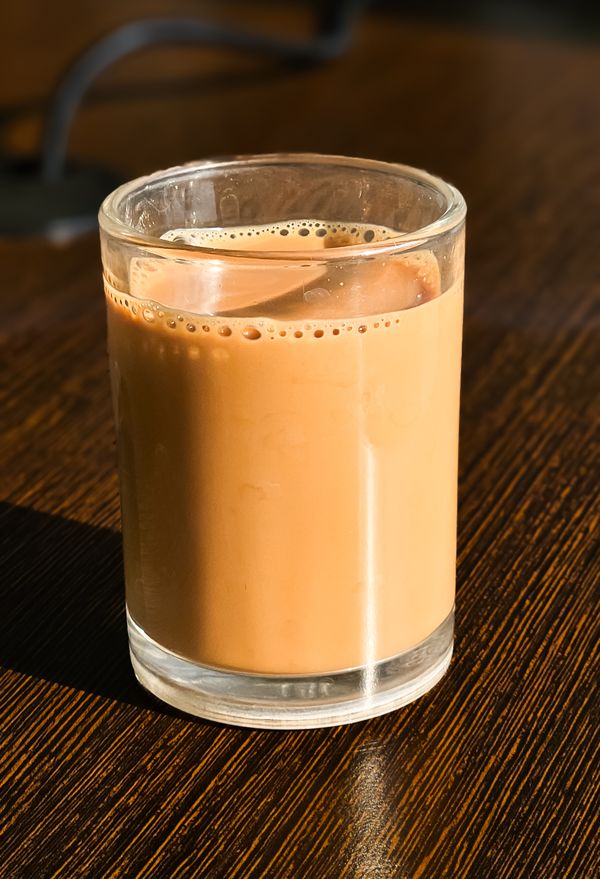 House karak chai in a tall cut-glass